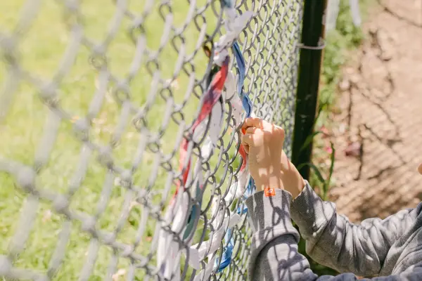 art project on chain linked fence