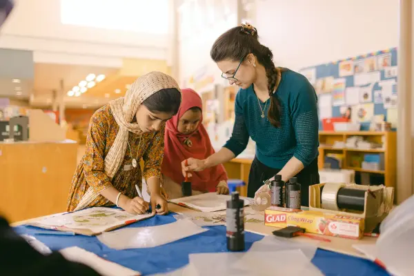 young changemakers painting in classroom